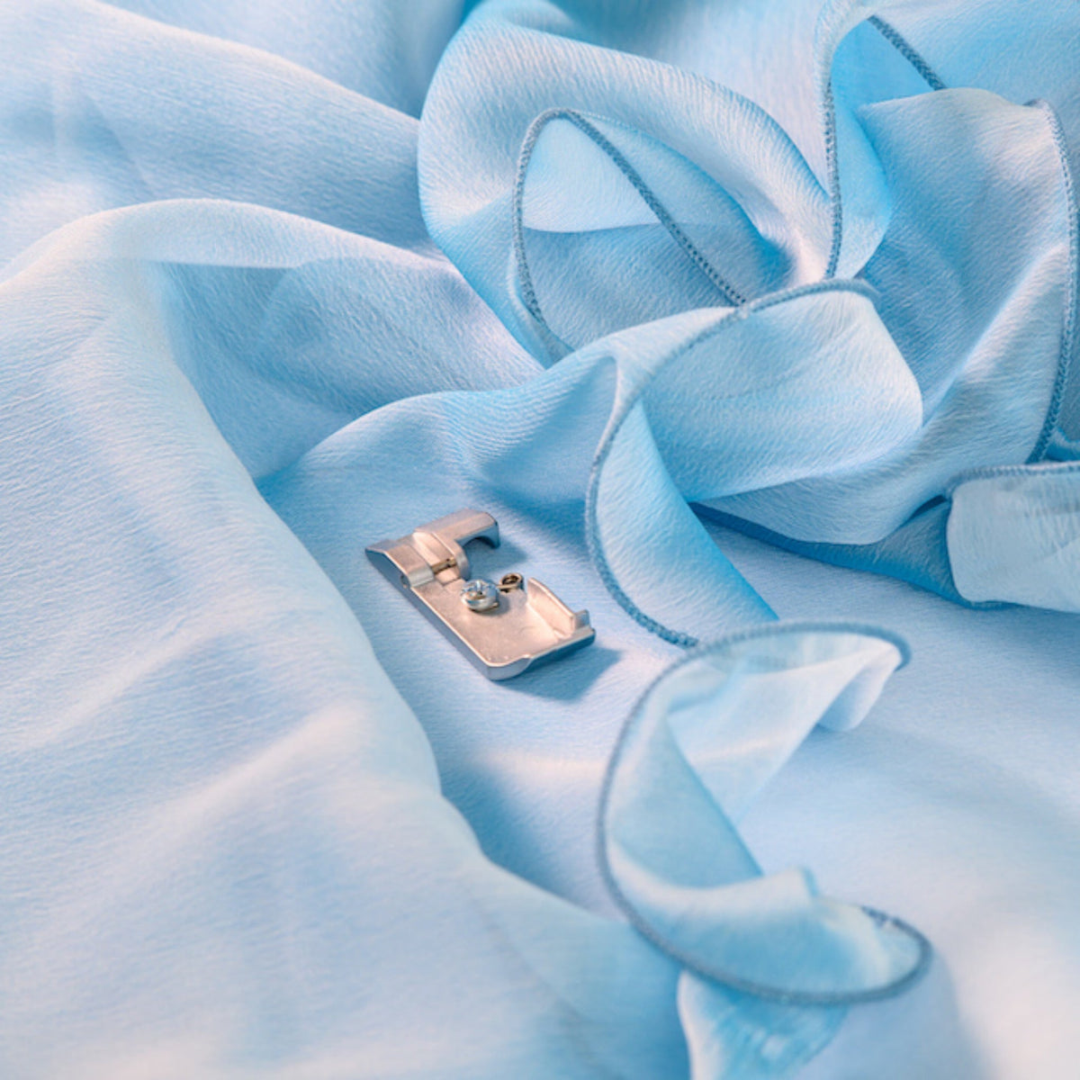 Cording foot on a textured blue fabric surface